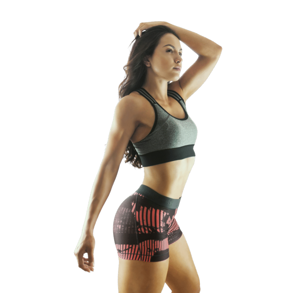 Fit woman in workout clothes posing confidently, representing postpartum fitness, strength, and self-care for moms.